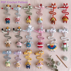May include: A collection of colorful, handmade crochet animal toys, including mice, crocodiles, foxes, and giraffes. Each toy has a long, wavy neck and is dressed in miniature outfits. The text "PDF Crochet Pattern" is at the top.