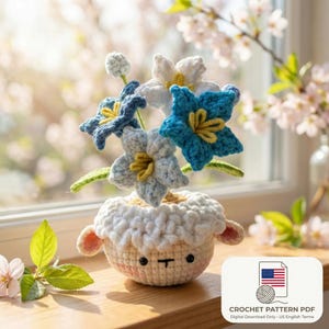 May include: A crocheted sheep-shaped flower pot holding blue, white, and light blue crocheted flowers with yellow centers. The pot has a cream-colored body and a white, fluffy top. The image includes a digital download graphic.