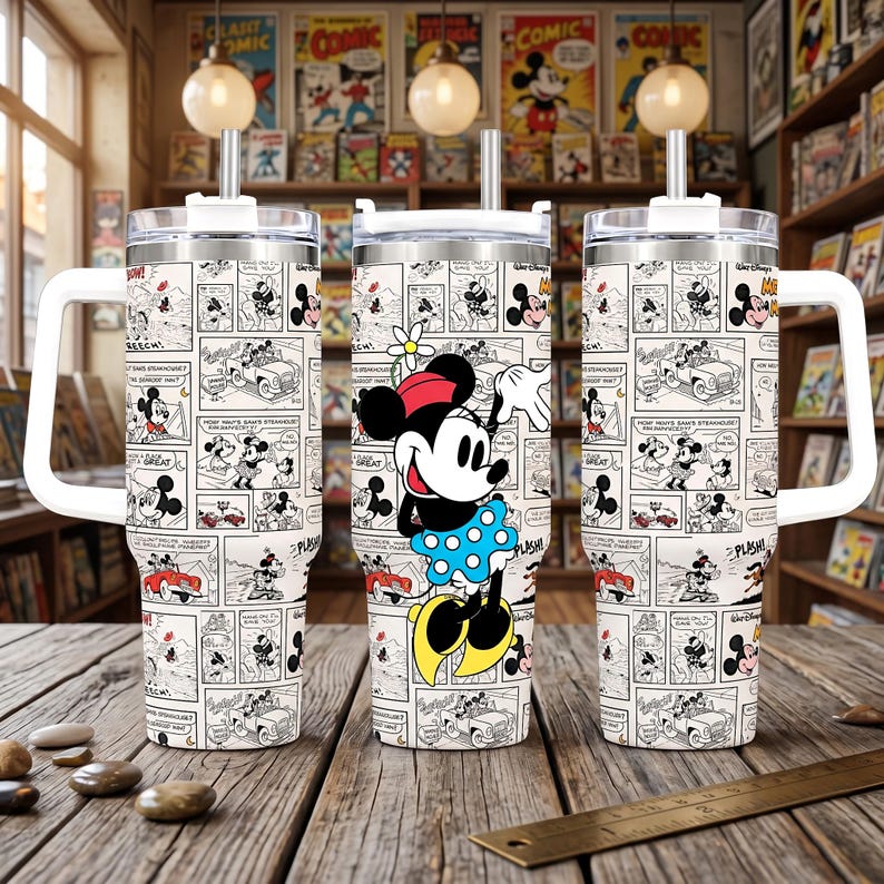 May include: A stainless steel tumbler with a handle and straw, featuring a black and white comic strip pattern of Mickey Mouse and Minnie Mouse. The center tumbler displays a large, colorful illustration of Minnie Mouse wearing a blue polka dot skirt.