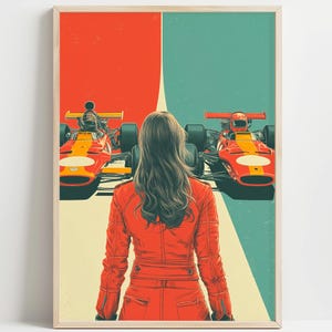 May include: A framed art print featuring a woman in a red racing suit, standing between two vintage red race cars. The background is divided into red and teal sections, with a cream-colored racing stripe down the center.