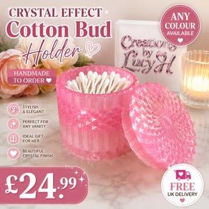May include: A pink, translucent, faceted cotton bud holder with a matching removable lid. The container is filled with white cotton swabs. Text on the image includes "CRYSTAL EFFECT Cotton Bud Holder", "HANDMADE TO ORDER", "ANY COLOUR AVAILABLE", "Creations by Lucy H", and "£24.99".