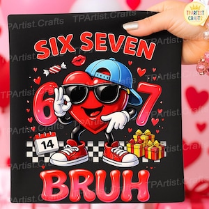 May include: Black graphic tee with a cartoon heart wearing sunglasses and a blue cap. The design includes the words "SIX SEVEN BRUH", a calendar showing the date 14, and gift boxes. Red and white accents.