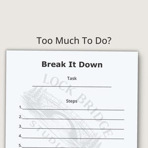 May include: A white paper with the text "Too Much To Do? Break It Down" in black. The paper has lines for tasks and steps, with the Lock Bridge Studio logo at the bottom. The background is a light beige color.