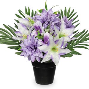 May include: A floral arrangement featuring purple dahlias, white lilies with purple edges, and green foliage. The flowers are in a black pot, creating a striking contrast. This artificial flower arrangement is suitable for home decor.