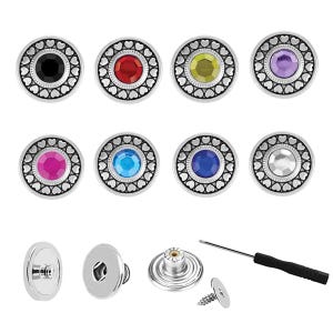 May include: A collection of interchangeable jewelry snaps with various colored gemstone centers, including black, red, yellow, purple, pink, blue, and clear. Each snap has a silver-colored, heart-patterned border. Additional components include a snap base, a screw, and a screwdriver.