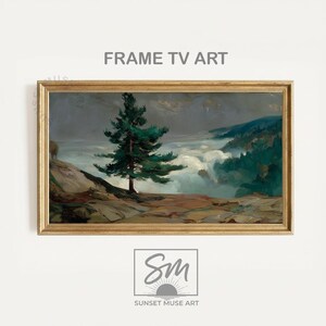 May include: A framed landscape painting featuring a tall evergreen tree on a rocky outcrop overlooking a misty valley. The artwork has a gold-colored frame and the text "FRAME TV ART" is at the top.