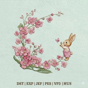May include: An embroidered design featuring a bunny in pink overalls reaching for a butterfly. The bunny is surrounded by a floral wreath of pink flowers and green leaves. The background is a light blue fabric. Text at the bottom reads: DST | EXP | JEF | PES | VP3 | HUS.