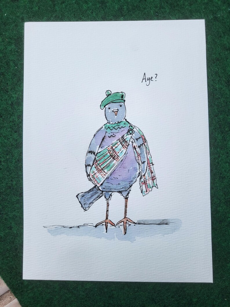 May include: A watercolor illustration on white paper depicting a grey bird wearing a green tam o' shanter hat and a green, red, and white plaid sash pinned with a brooch. The bird has thin orange legs and the text Aye? is written above it.