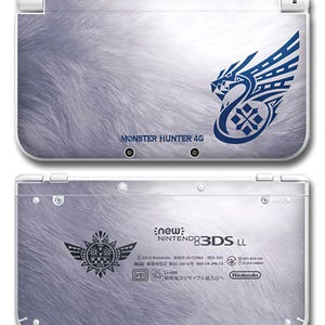 May include: A New Nintendo 3DS LL console with a white and grey fur-like design. The top features the text "MONSTER HUNTER 4G" and a blue emblem. The bottom has a black emblem and the text "new Nintendo 3DS LL".