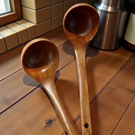 A rustic hand-carved wooden ladle with 114 favorites proving real people keep buying this — the kind of tactile, earthy kitchen tool that feels like it came from a farmhouse workshop.