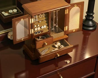 Wooden jewelry cabinet featuring glass doors and a velvet-lined interior