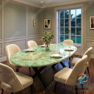 May include: An oval dining table with a polished green onyx stone top featuring natural brown veining, supported by a black metal cross-base. Six upholstered cream-coloured chairs with curved backs are arranged around the table.