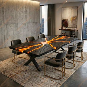 May include: A contemporary dining table with a distinctive design. The black wooden table has a bright orange resin inlay, creating a striking contrast. The table is supported by black metal legs and surrounded by grey chairs with gold frames. The table is approximately 254 cm long.