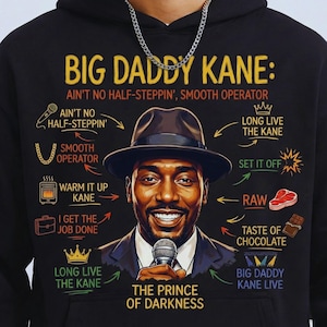 May include: Black hoodie featuring a portrait of Big Daddy Kane with text that reads "Big Daddy Kane: Ain't No Half-Steppin', Smooth Operator." The design includes illustrations and phrases associated with the rapper.