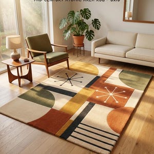 May include: A rectangular area rug featuring a geometric pattern with cream, mustard yellow, burnt orange, and dark green shapes, including starburst motifs and parallel lines. The rug is labeled MID-CENTURY ATOMIC AREA RUG - 8x10.