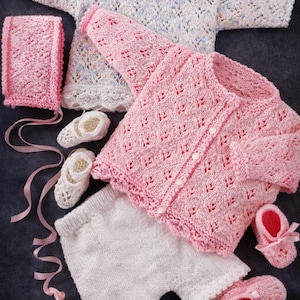 May include: A white ceramic mug with a black handle and the text "But First, Coffee" in a bold, black font. The mug is set against a blurred background, suggesting a cozy setting. The mug appears to be approximately 4 inches tall.