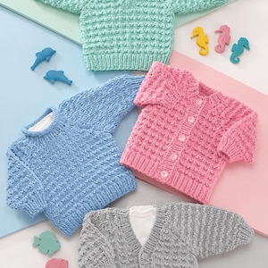 May include: Four knitted sweaters in mint green, light blue, pink, and gray, each featuring a textured waffle stitch pattern. The pink and gray sweaters have front button closures, while the mint green and light blue sweaters are pullovers.