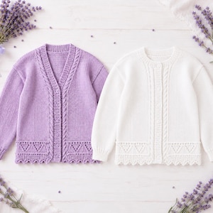 May include: Two long-sleeved knit cardigans, one in light purple and one in white. Both feature a V-neckline, a vertical cable knit pattern along the button placket, and a decorative triangular lace pattern along the bottom hem with a scalloped edge.