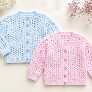 May include: Two long-sleeved knit cardigans, one in light blue and one in light pink. Both garments feature an openwork stitch pattern, a ribbed crew neckline, and a vertical row of matching circular buttons down the centre front placket.