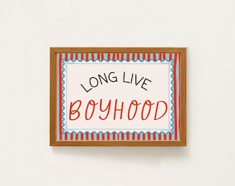 May include: A framed print with the words "LONG LIVE BOYHOOD" in black and red lettering. The print has a white background with a blue and red striped border and a wooden frame. The artwork is a decorative piece.