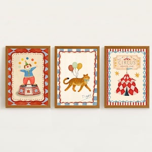 May include: A set of three framed prints with a circus theme. One shows a clown on a pedestal, another a tiger with balloons, and the last a circus tent with the words "Circus Admits One". Each print has a decorative border.