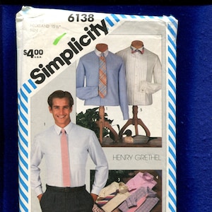 May include: Simplicity sewing pattern number 6138 for a men's shirt. The pattern includes instructions on how to work with plaids. The pattern is for a long-sleeved shirt with a collar and a button-up front. The pattern is by Henry Grethel.
