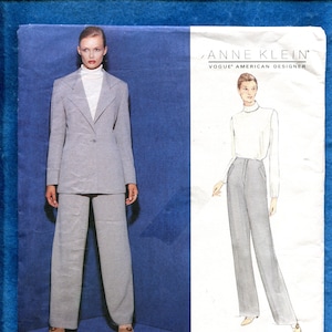 May include: Vogue Patterns sewing pattern featuring an Anne Klein design. The pattern includes a suit with a blazer and wide-leg pants. The image shows a woman wearing the suit and a sketch of the design. The pattern size is 14-16-18.
