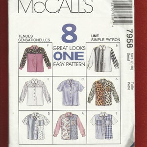 May include: McCall's sewing pattern featuring eight shirt designs. The pattern includes various styles, such as striped, floral, and animal print shirts. The package includes the text "Great Looks One Easy Pattern" and size information.