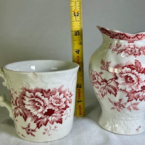 May include: A rustic wooden sign with the text "Welcome to our home" in white lettering. The sign features a distressed finish and a simple, inviting design, perfect for front door decor.