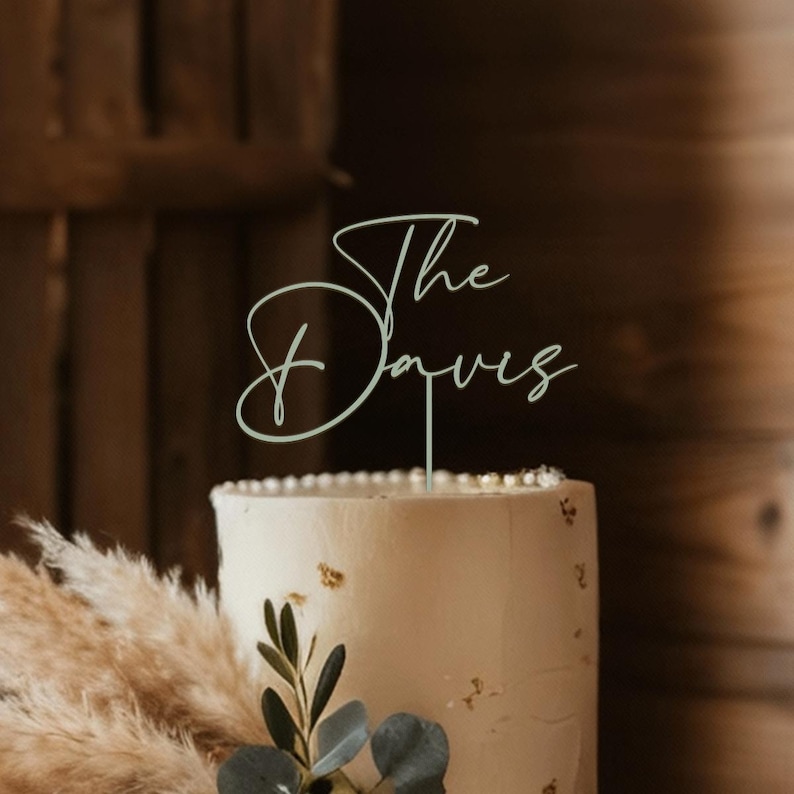 May include: A set of three ceramic mugs with a speckled, cream-colored glaze. Each mug features a different hand-painted floral design in shades of blue, green, and yellow. The mugs have a simple, rounded shape and a comfortable handle.
