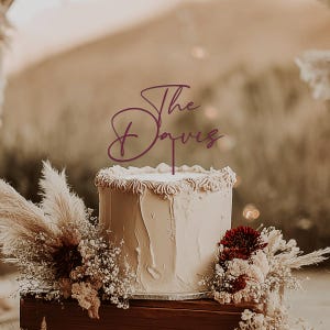 May include: A handmade wooden sign with the text "Welcome" in a playful font. The sign features a distressed white background and a dark brown frame, perfect for a front door or entryway. The sign measures approximately 12 inches wide and 6 inches tall.