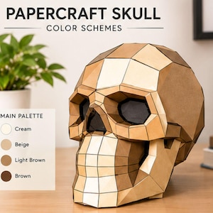 May include: A geometric papercraft skull sculpture constructed from tan and light brown polygonal panels. The text PAPERCRAFT SKULL COLOR SCHEMES is visible at the top, with a MAIN PALETTE list showing cream, beige, light brown, and brown circles.