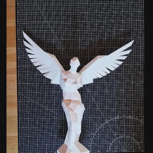 May include: A papercraft sculpture of an angel with outstretched wings. The figure is constructed from white and light brown geometric shapes, creating a three-dimensional effect. The wings are wide and detailed, and the angel stands on a black grid surface.