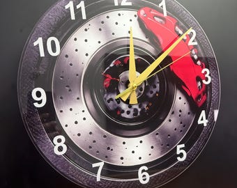 Reloj de pared con forma de disco de freno, diseño de rueda de Fórmula Uno, cristal templado con pinza de freno roja y manecillas doradas.