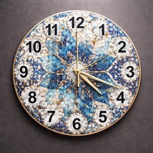May include: Round wall clock with a gold-colored frame. The clock face features a mosaic design in shades of blue and white, with black numerals and gold-colored hands. The clock's design is reminiscent of a flower.