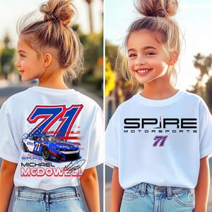 May include: A white short-sleeve t-shirt featuring a graphic print. The front displays the black text Spire Motorsports above the number 71. The back shows a blue race car with the number 71, the text Michael McDowell, and a signature.