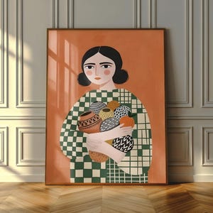 May include: A framed art print featuring a woman holding several decorative vases. The woman has dark hair and is wearing a green and white checkered top. The background is a solid orange color.
