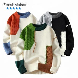 May include: Three colour-blocked sweaters with textured knit panels. One sweater features orange and blue accents, another green and brown, and the third grey and black. Each sweater has a cream-coloured base and the brand name "ZeeshMaison" at the top.