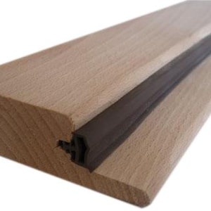May include: A section of light-colored wood with a dark brown rubber strip inset along its length. The wood has a smooth, finished appearance. The rubber strip appears to be a seal or gasket.