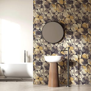 May include: A modern bathroom with a white bathtub and sink. The wall features a wallpaper design with a pattern of overlapping circles in shades of gray, yellow, and black. A round mirror hangs above the sink.