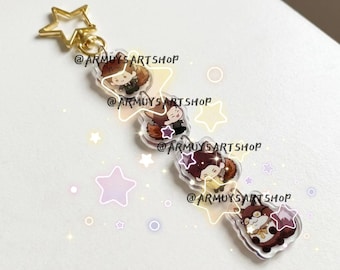 May include: A clear acrylic keychain featuring four connected charms of cartoon characters with brown animal ears and tails. The keychain has a gold-colored star-shaped clasp at the top. The text @ARMUYSARTSHOP is printed across the charms.