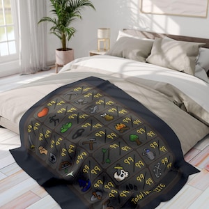 May include: A black blanket featuring a grid design with various icons and the number "99" repeated throughout. The blanket has a border and the text "Total Items 2376". The blanket is on a bed with neutral-toned bedding.