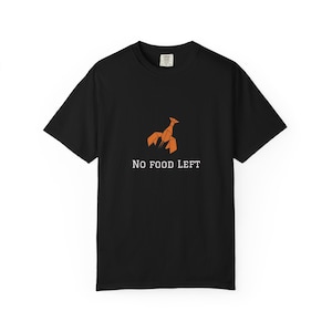 May include: Black t-shirt featuring an orange origami lobster design and the text "NO FOOD LEFT" in white. The shirt has short sleeves and a crew neck. A casual, everyday wear tee.