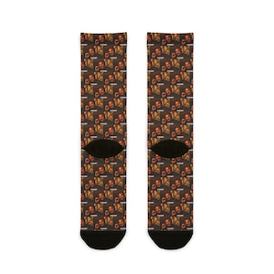 May include: A pair of socks featuring a repeating pattern of a person's face with the word "PAIN" in white text. The socks have black heels and toes.