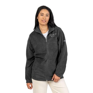 May include: A charcoal gray fleece jacket with a full zipper closure and a high collar. The jacket has the text "Stephen High School, Mrs. Crosby" embroidered on the chest. The Columbia logo is visible on the sleeve.