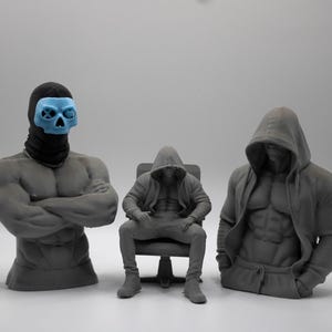 May include: Three gray 3D printed figures. On the left, a muscular torso bust wearing a black balaclava and a light blue skull mask. In the center, a seated figure in a hooded sweatshirt. On the right, a muscular torso bust wearing a hooded sweatshirt.