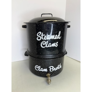 May include: A black speckled clam steamer pot with a lid and a spigot. The words "Steamed Clams" and "Clam Broth" are written in white script on the pot.