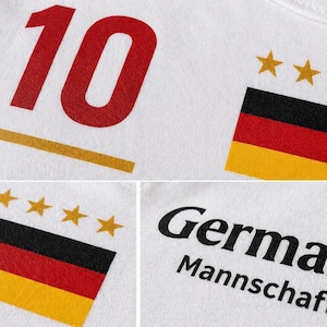 May include: White t-shirt with the number 10 in red, a gold horizontal line, and the German flag with four gold stars. The word "Germany" and "Mannschaft" are printed in black.