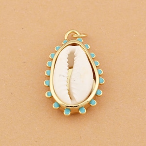 May include: Gold-tone pendant featuring a white seashell encased in a gold frame with turquoise accents. The pendant has a loop for attaching to a chain or cord. The design is oval-shaped and has a coastal or nautical theme.