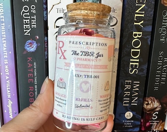 May include: A clear glass jar with a cork stopper, filled with colorful paper slips. The label reads Prescription The TBR Jar Pharmacy, Books Are My Medicine, RX#: TBR-001, Dosage: A book whenever the urge to read strikes, Refills: Unlimited, Reading Is Self Care.